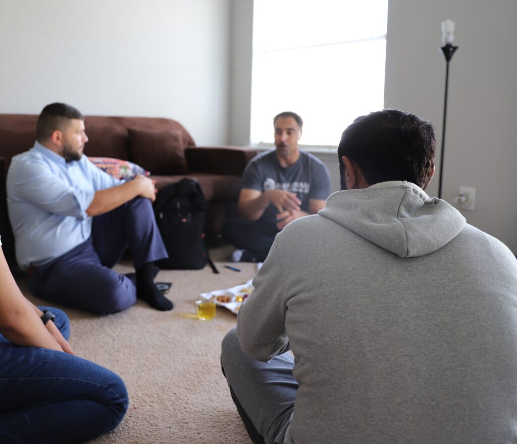 Ahmad and Rez at a home visit talking to a recent arrival veteran